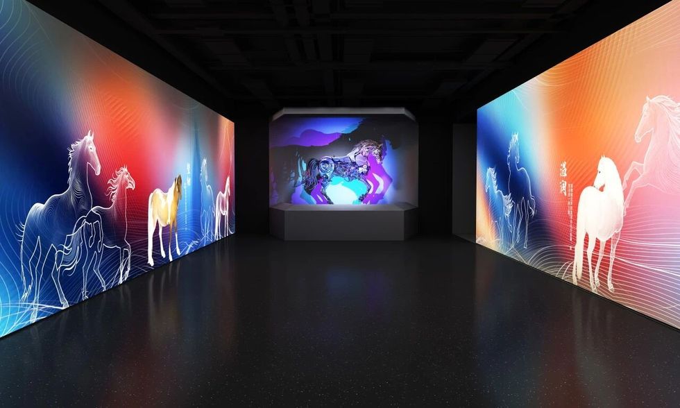 Colorful digital art installation of horses on vibrant panels in a dark room.