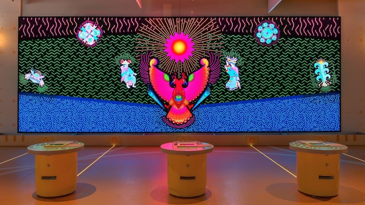 Colorful digital mural with abstract patterns and mystical creatures on a screen display.