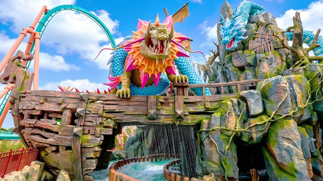 Colorful dragon sculpture adorns a theme park ride at Xiaogan Fantawild Resort with water below.