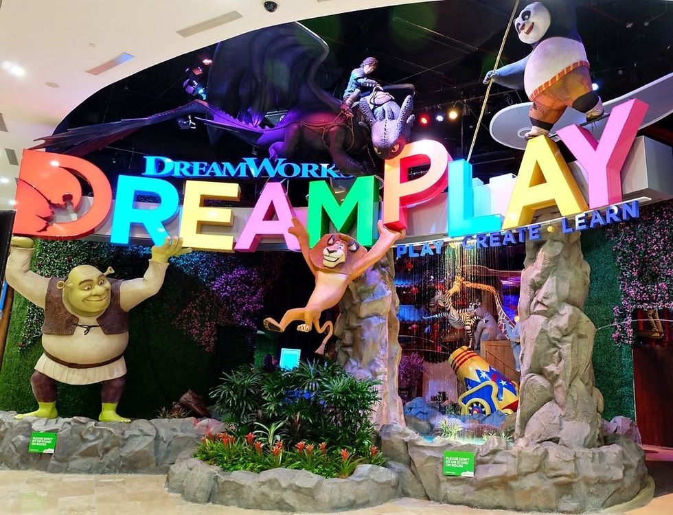 Colorful "DREAMPLAY" sign with characters from DreamWorks movies.