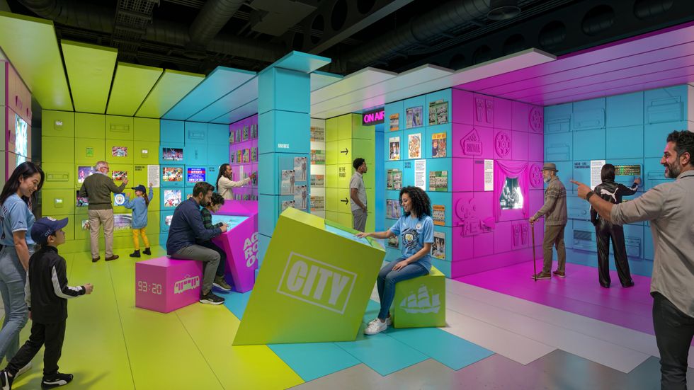 Colorful exhibit space with interactive displays and visitors exploring the Manchester City Museum Experience