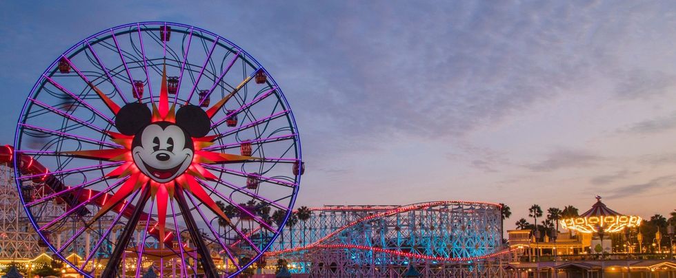Colorful Ferris wheel with Mickey Mouse design at sunset in Disney California Adventure