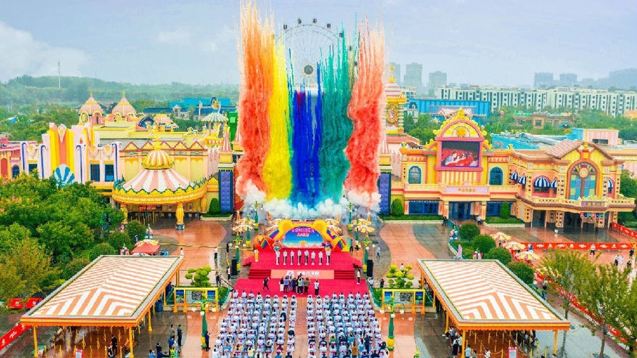 Colorful fireworks display above Boonie Bears theme park with cheering crowd below.