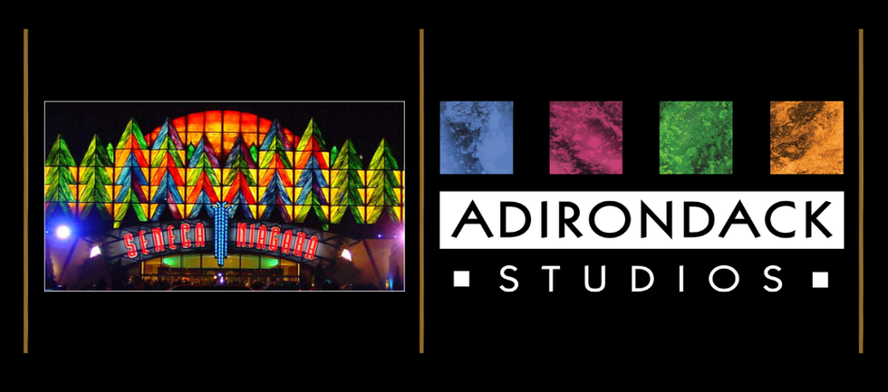Colorful geometric lights on a building with "Adirondack Studios" text beside it.