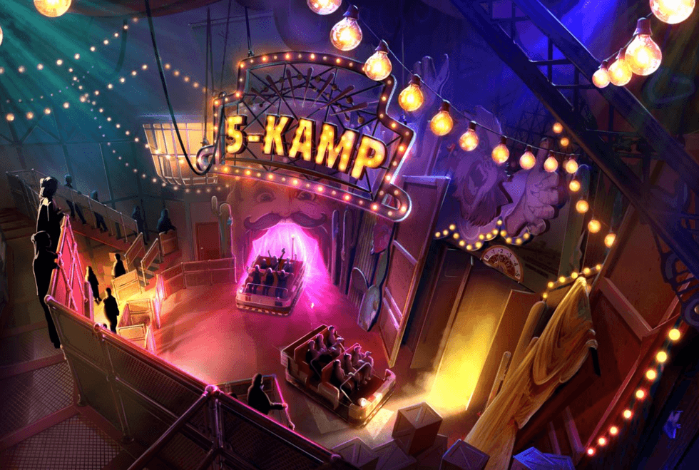 Colorful indoor amusement ride with a glowing 5-KAMP sign and seated passengers.