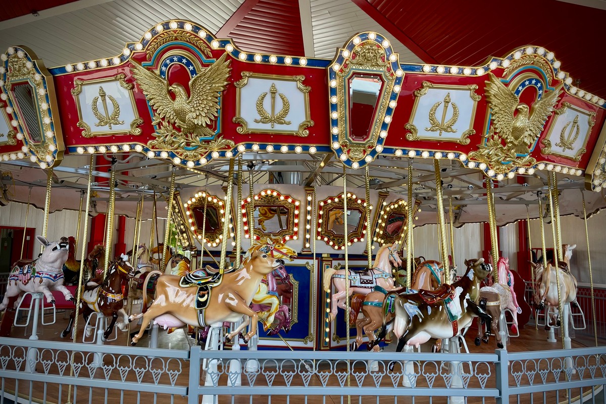 Colorful indoor carousel with ornate decorations and animal seats.