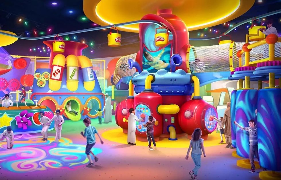 Colorful indoor playground with kids playing, featuring vibrant, oversized toy structures.