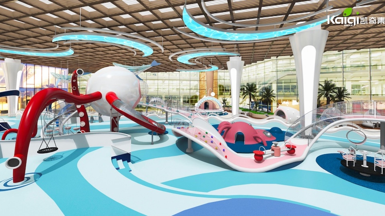 Colorful indoor playground with slides, climbing structures, and modern design elements.