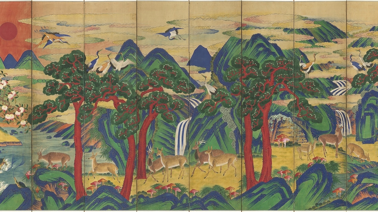 Colorful landscape with cranes, deer, red sun, and trees on a multi-panel screen.
