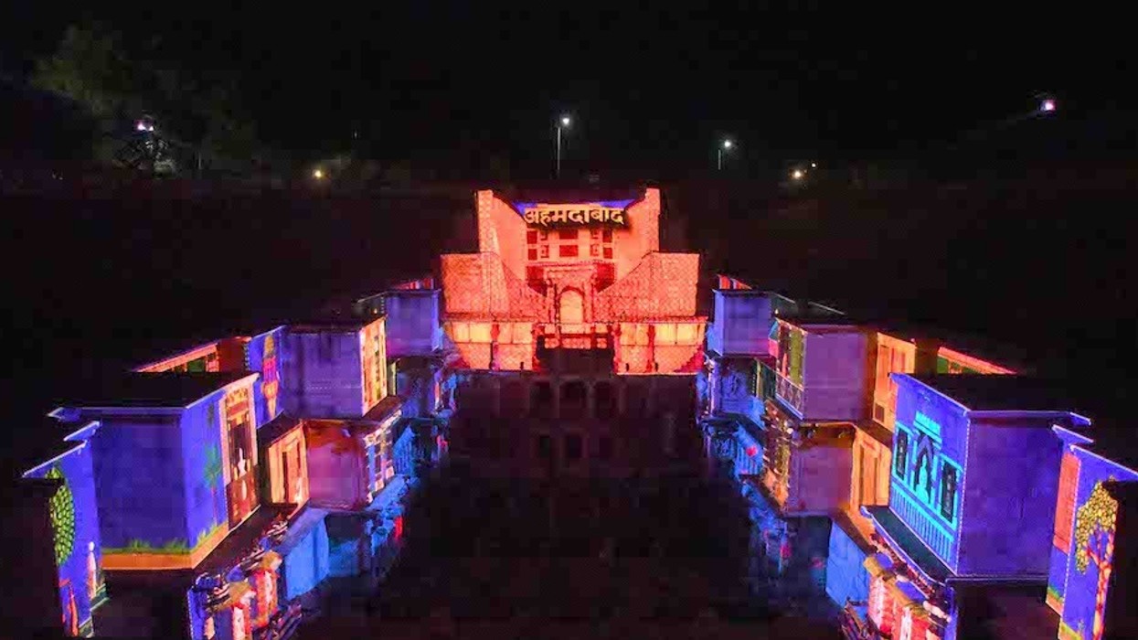 Colorful lights illuminate the historic stepwell at night.