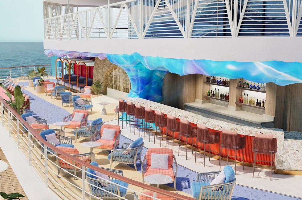 Colorful outdoor bar with ocean view, wicker chairs, and abstract blue overhead decor.