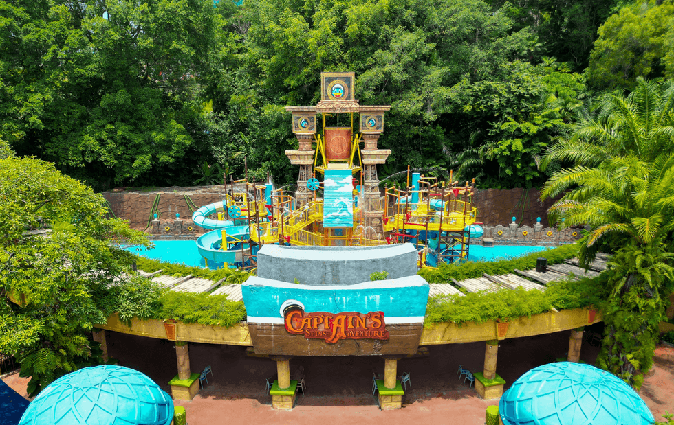 Colorful pirate-themed water ride at Sunway Lagoon with slides and lush greenery.