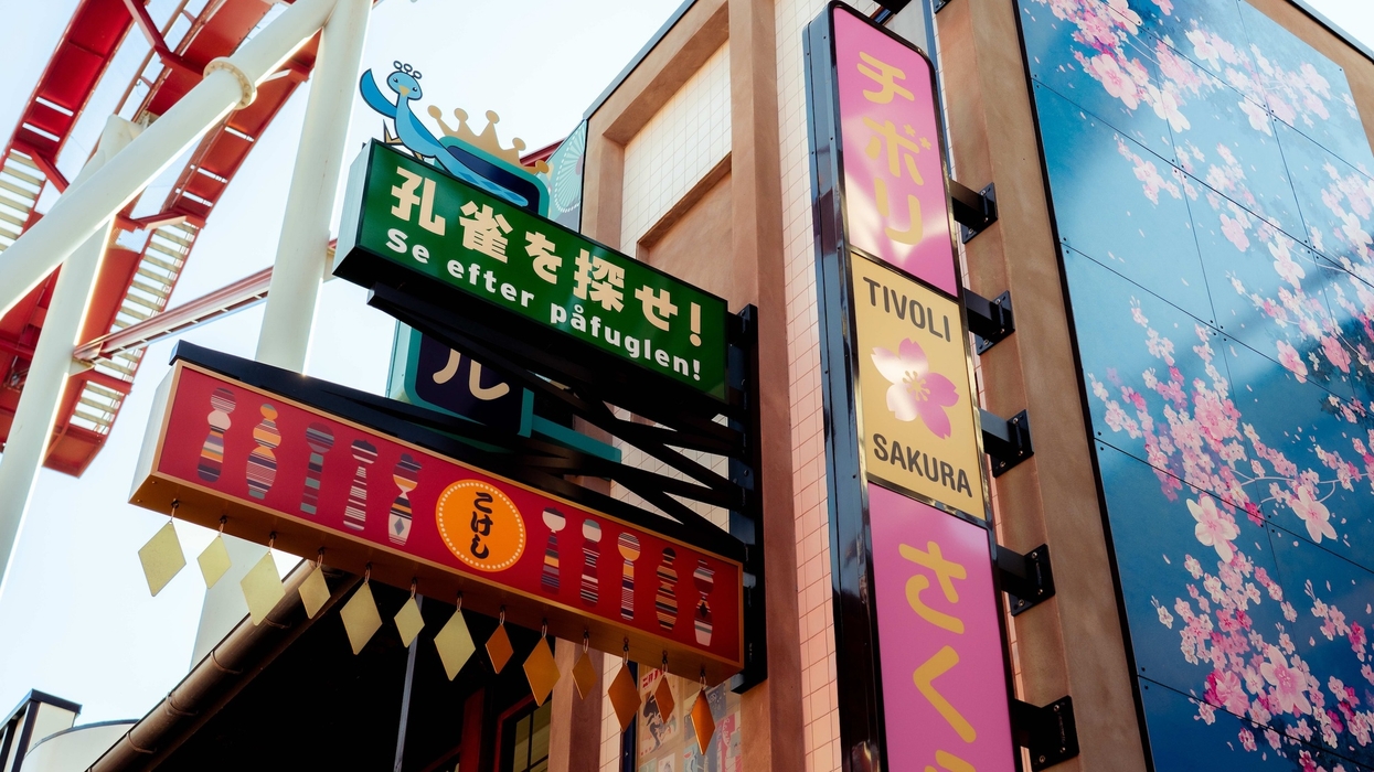 Colorful signs and cherry blossom mural at the Tivoli amusement park