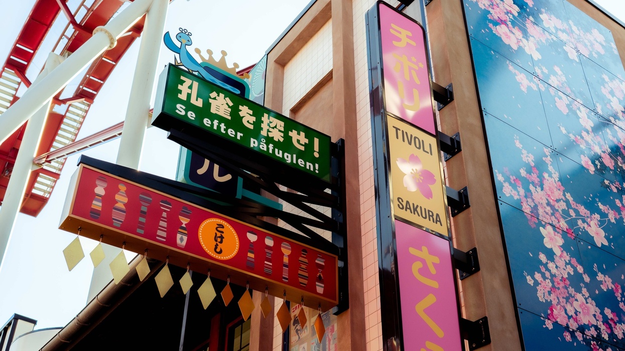 Colorful signs and cherry blossom mural at the Tivoli amusement park