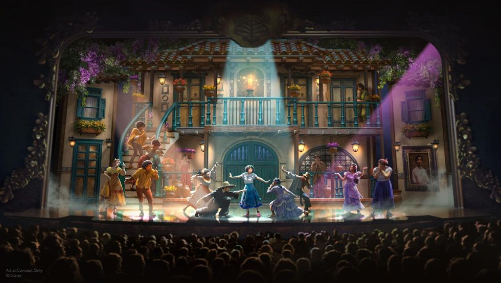 Colorful stage play with dancers and a decorative house backdrop on the Disney Believe