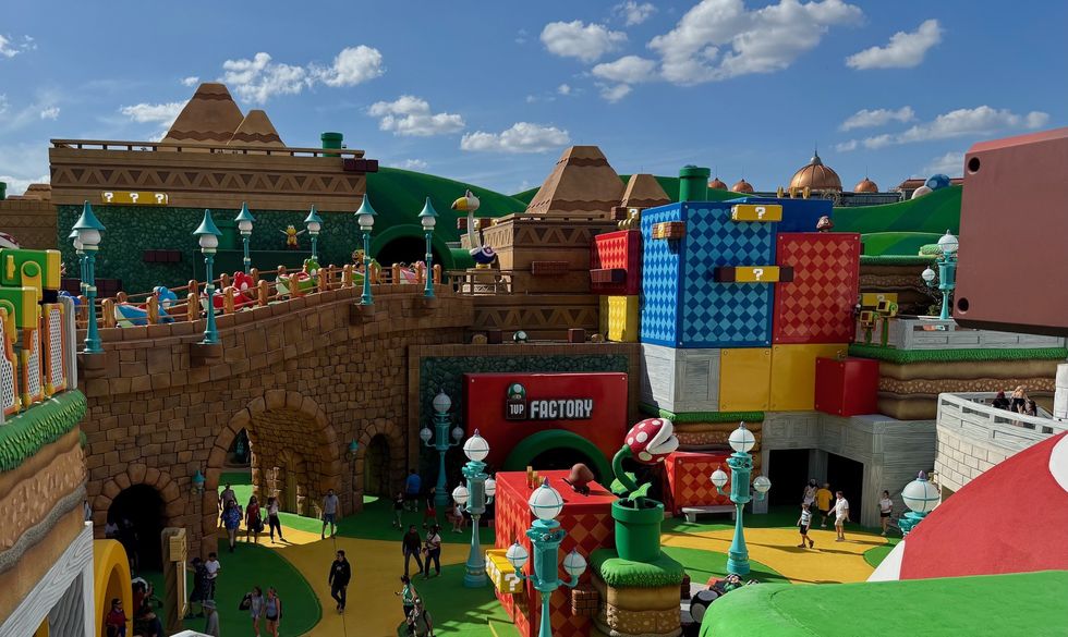 Colorful theme park area with blocks, arches, and a clear blue sky.