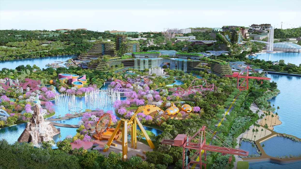 Colorful theme park with rides, greenery, and pink trees by the water in Greater Sentosa