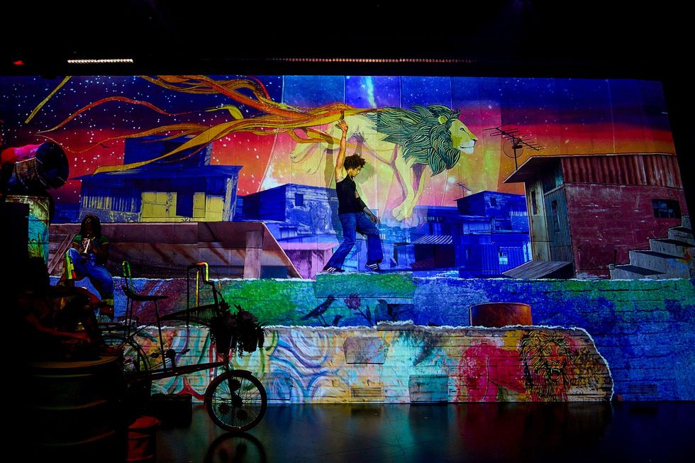 Colorful urban mural with lion, figures, and vibrant night sky.