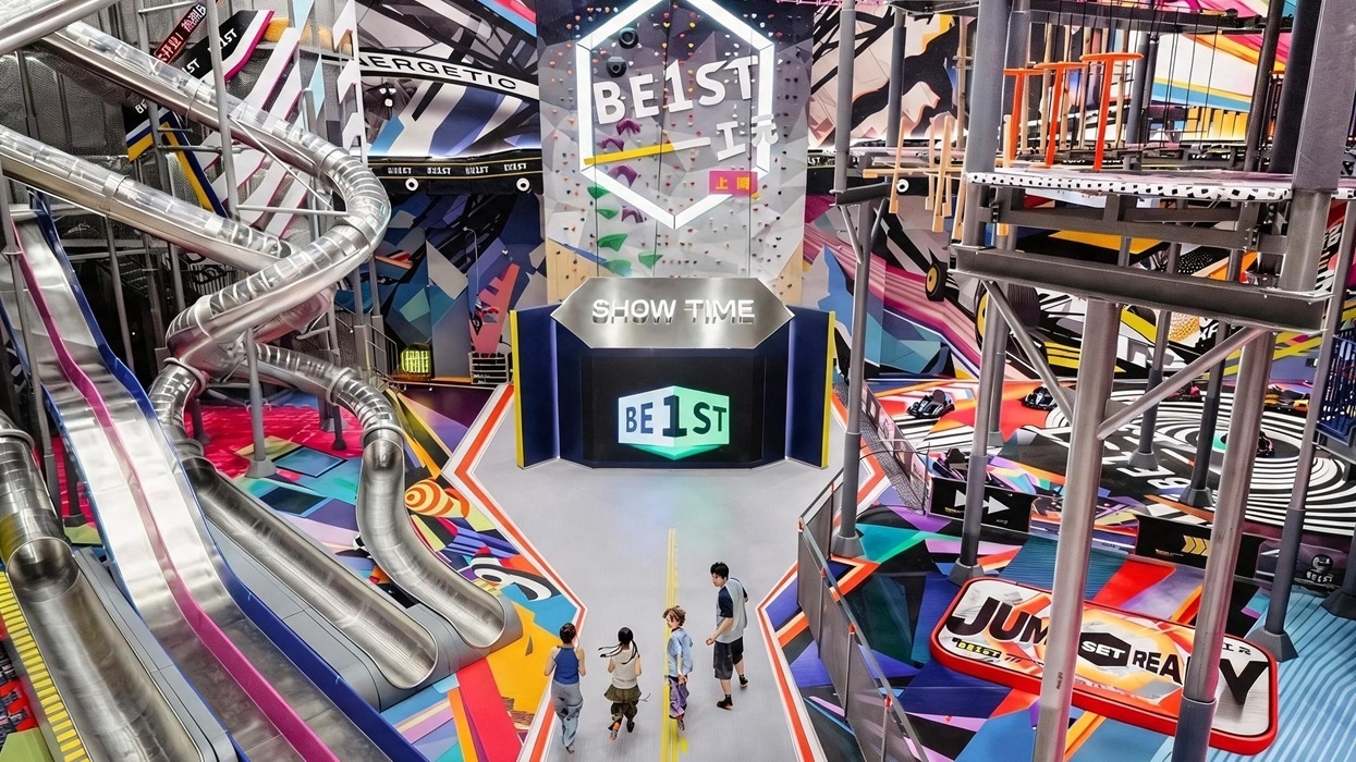Colourful indoor BE1ST adventure park with multi-level slides and climbing structures.