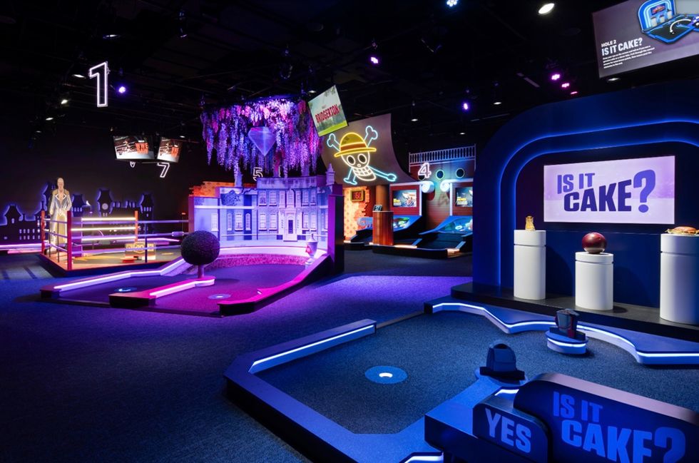 Colourful mini golf course from 360Golf with neon lights and "Is It Cake?" themed displays.