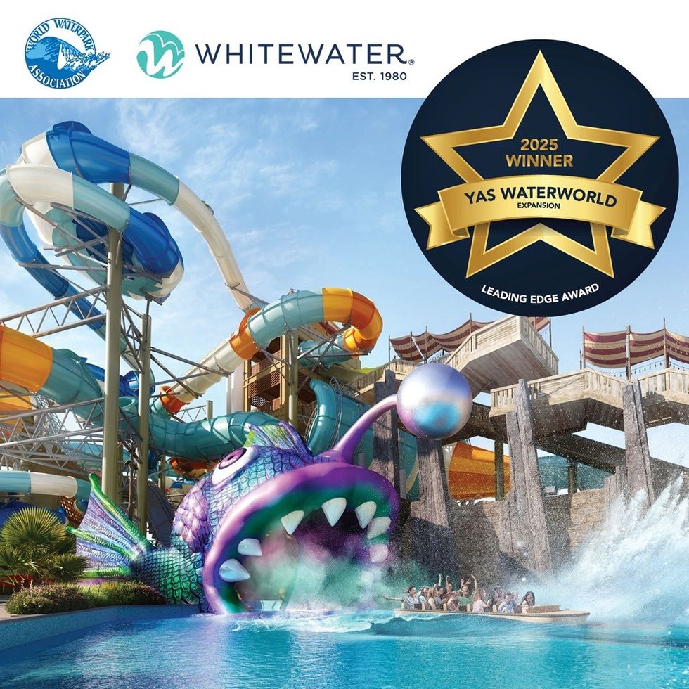 Colourful water slide with fish design at Yas Waterworld; 2025 award badge displayed.