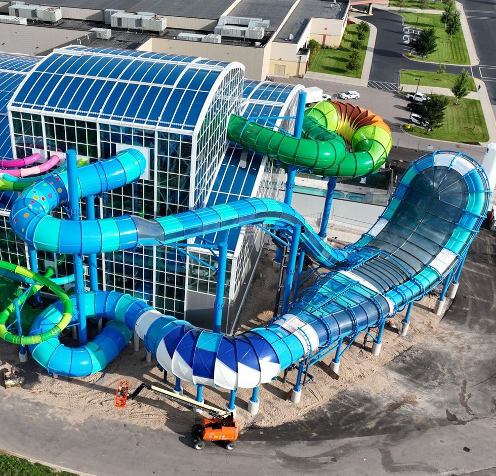 Colourful water slides wrapping around a large, glass-roofed building at Wisconsin Dells