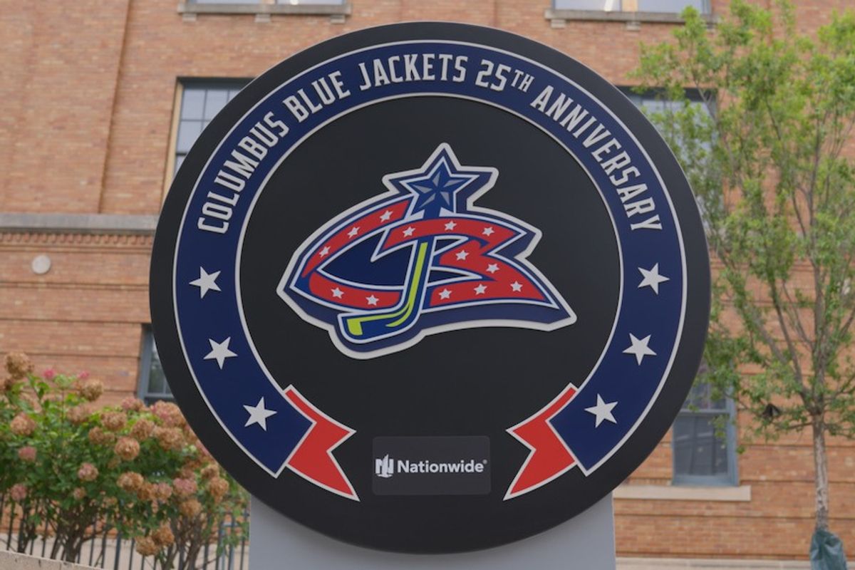 Columbus Blue Jackets 25th Anniversary sign in front of a brick building.