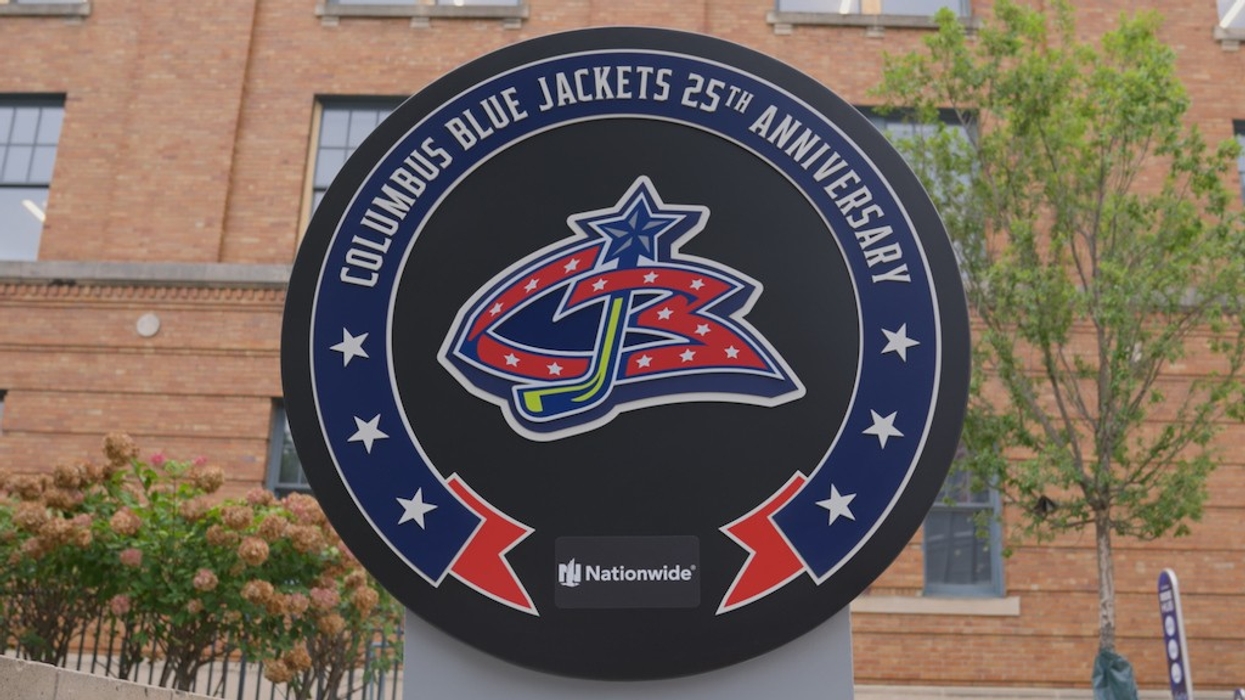 Columbus Blue Jackets 25th Anniversary sign in front of a brick building.