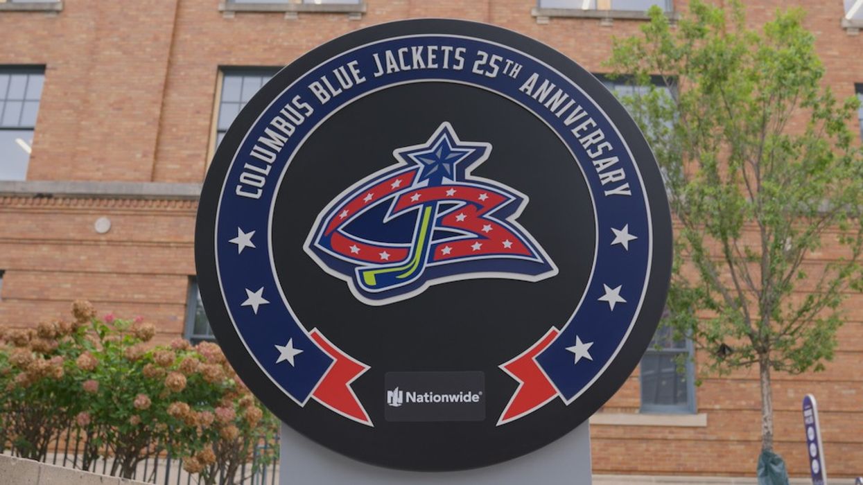 Columbus Blue Jackets 25th Anniversary sign in front of a brick building.