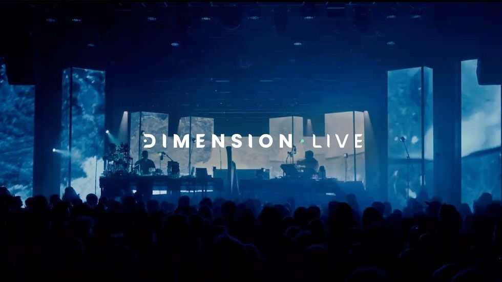 Concert stage with blue lighting and "Dimension Live" text above the crowd.