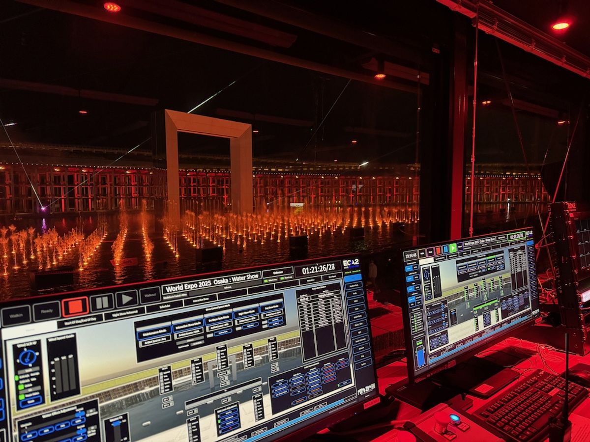 Control room overseeing a lit water show with screens displaying software controls