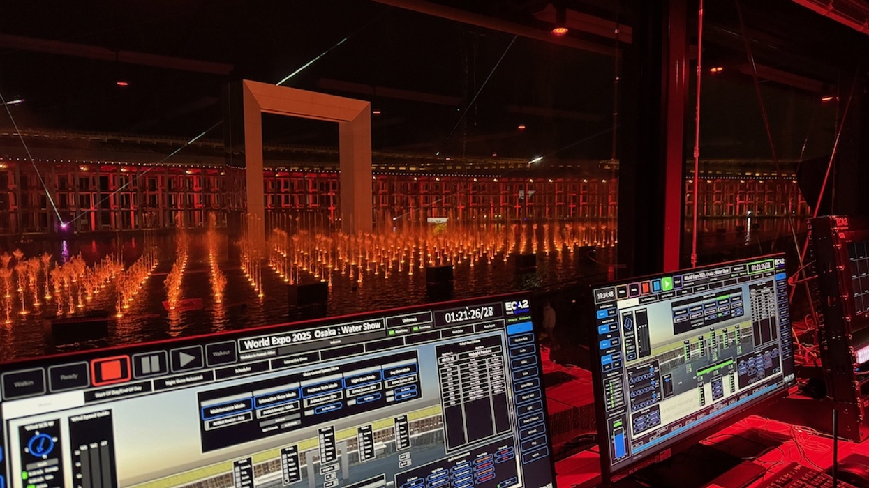 Control room overseeing a lit water show with screens displaying software controls