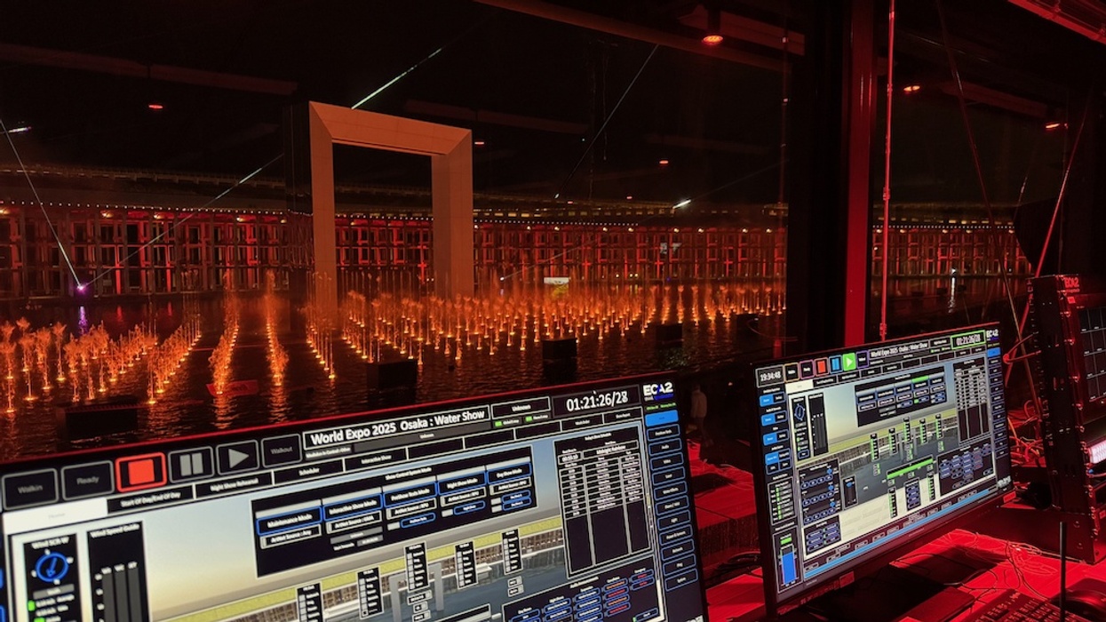 Control room overseeing a lit water show with screens displaying software controls