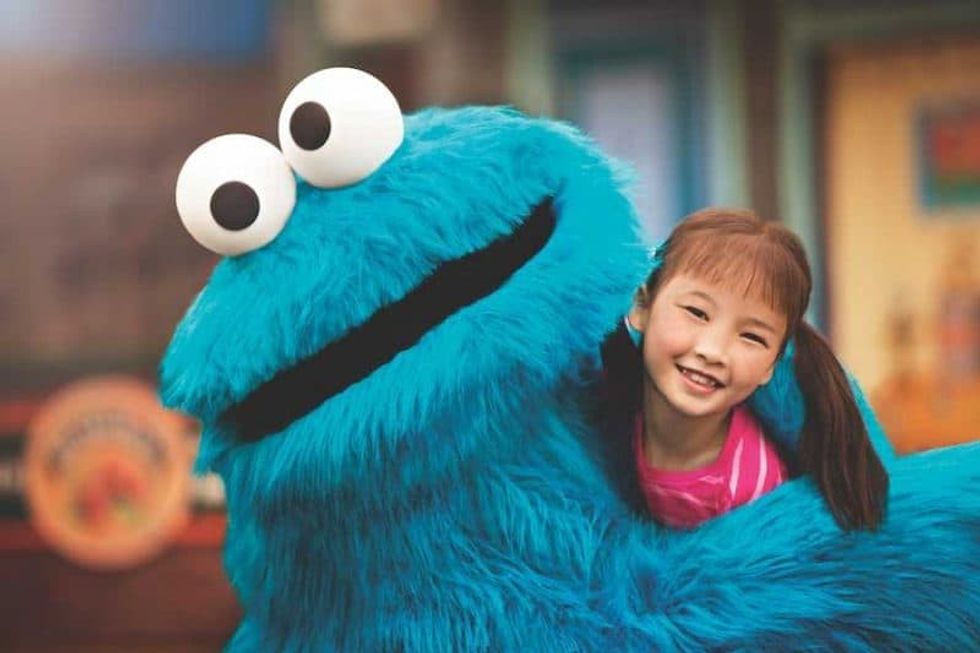 Cookie Monster hugging little girl at SeaWorld Orlando