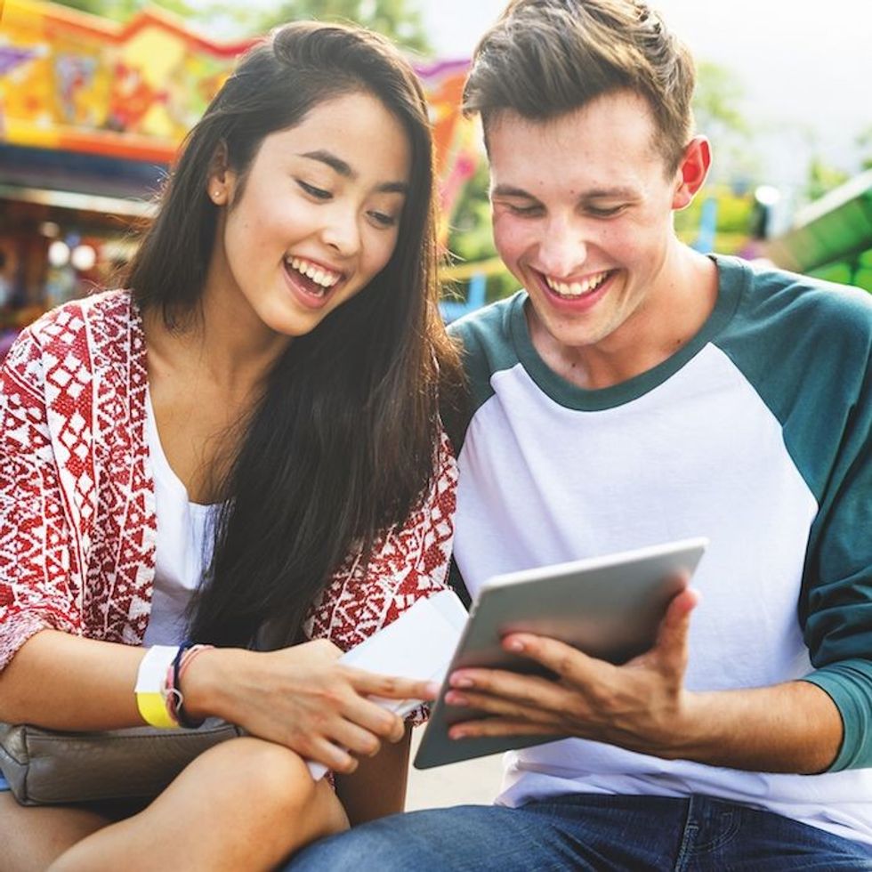 couple look at ipad for theme park ticketing sollutions