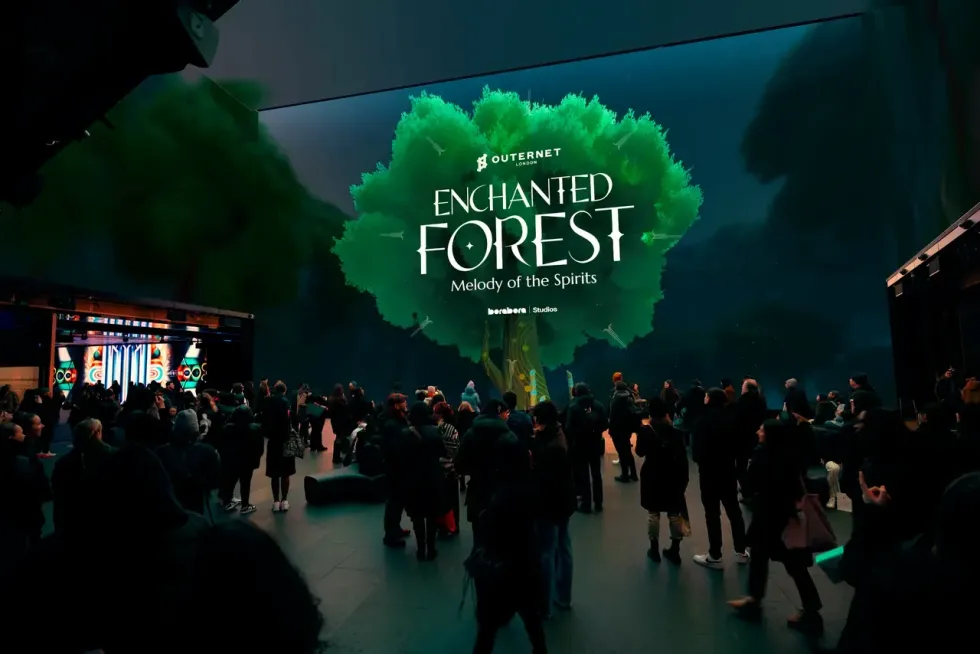 Crowd at "Enchanted Forest" immersive event with a large tree display.