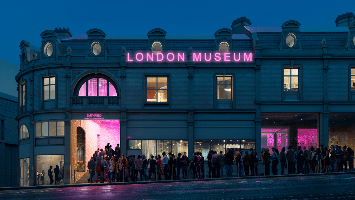 Crowd outside London Museum at night, building lit with pink neon lights.