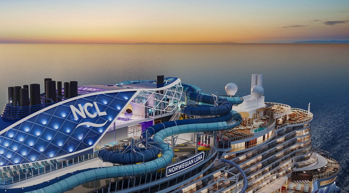 Cruise ship deck at sunset with waterslides and "NCL" signage.