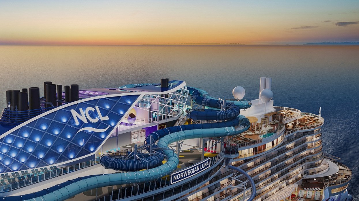 Cruise ship deck at sunset with waterslides and "NCL" signage.