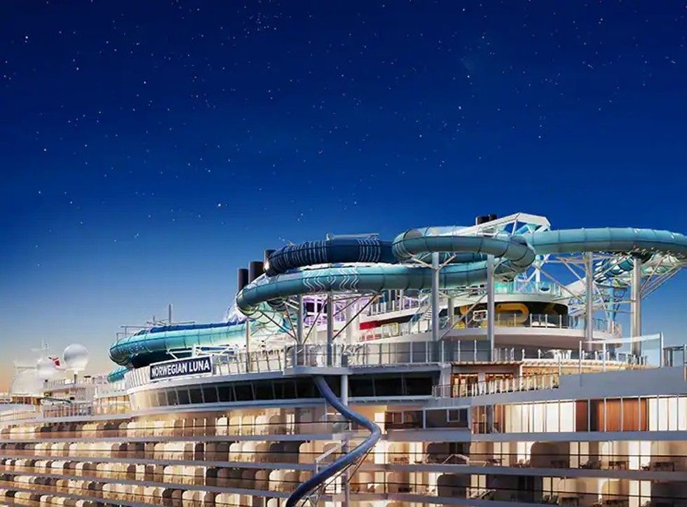 Cruise ship with twisty water slides under a starry night sky.