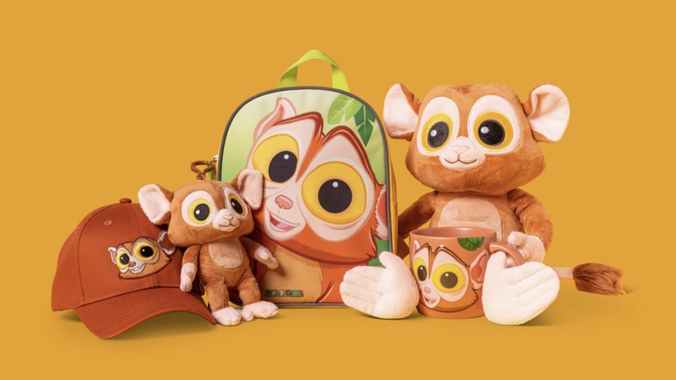 Cute cartoon lemur merchandise: backpack, plush toys, hat, and mug with big-eyed designs.
