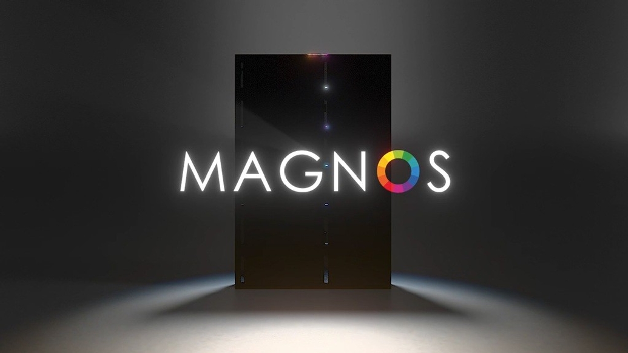 "Dark room with illuminated text 'MAGNOS' and a colorful circle on a black background."