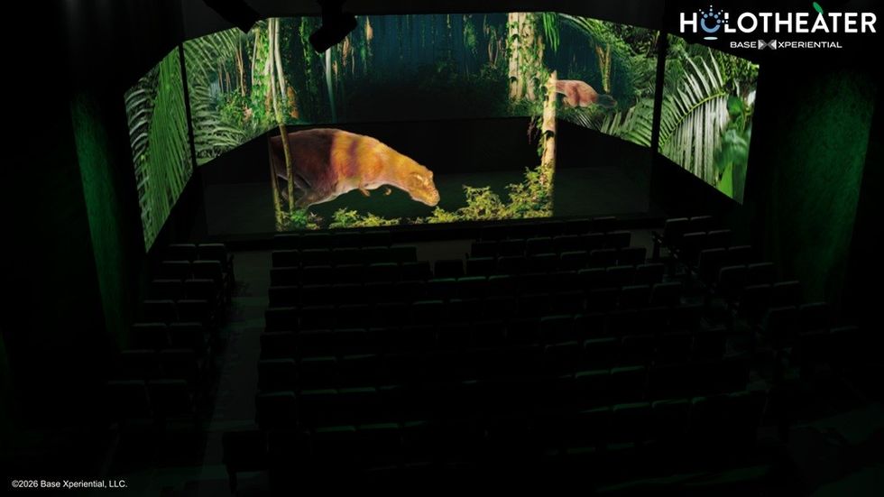 Dark theater showing a 3D forest scene with an animal on screen.