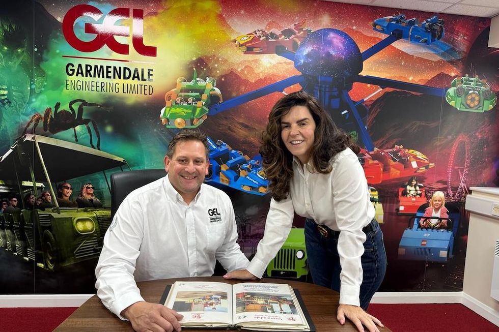 David and Zoe Shelmerdine office with a theme park mural behind them.