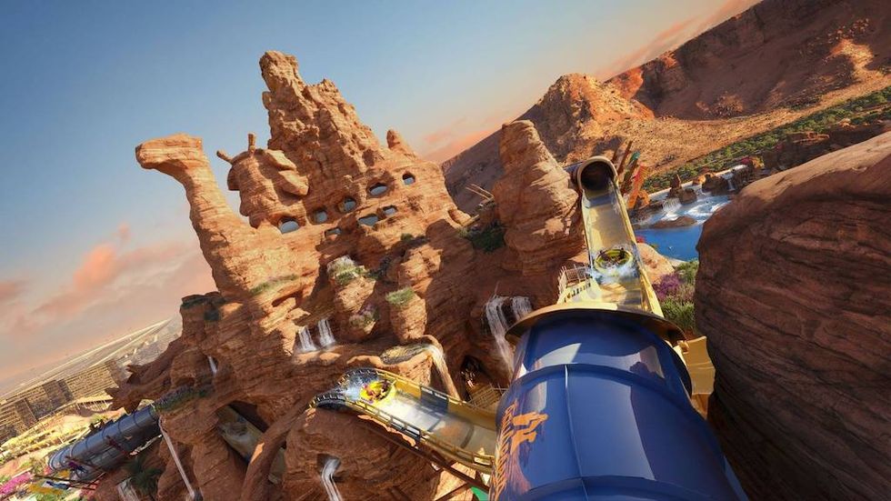 Desert-themed water park slide with rock formations and scenic view.