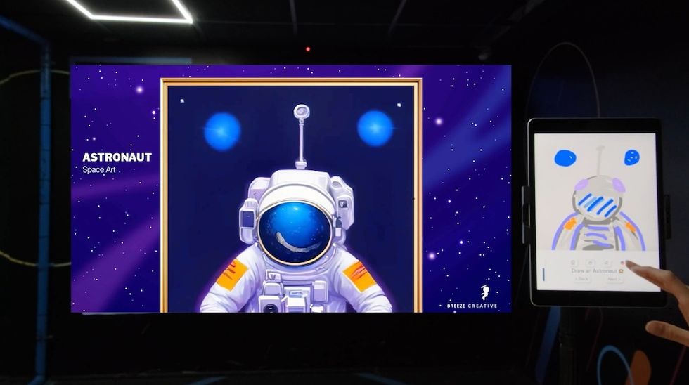 Digital astronaut art displayed on a screen with a drawing tablet nearby, Magic Painter