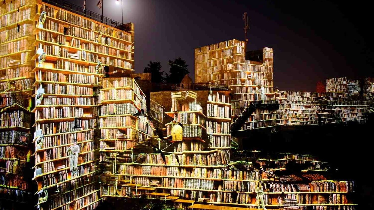 digital projection on tower of david museum jersusalem showing a library
