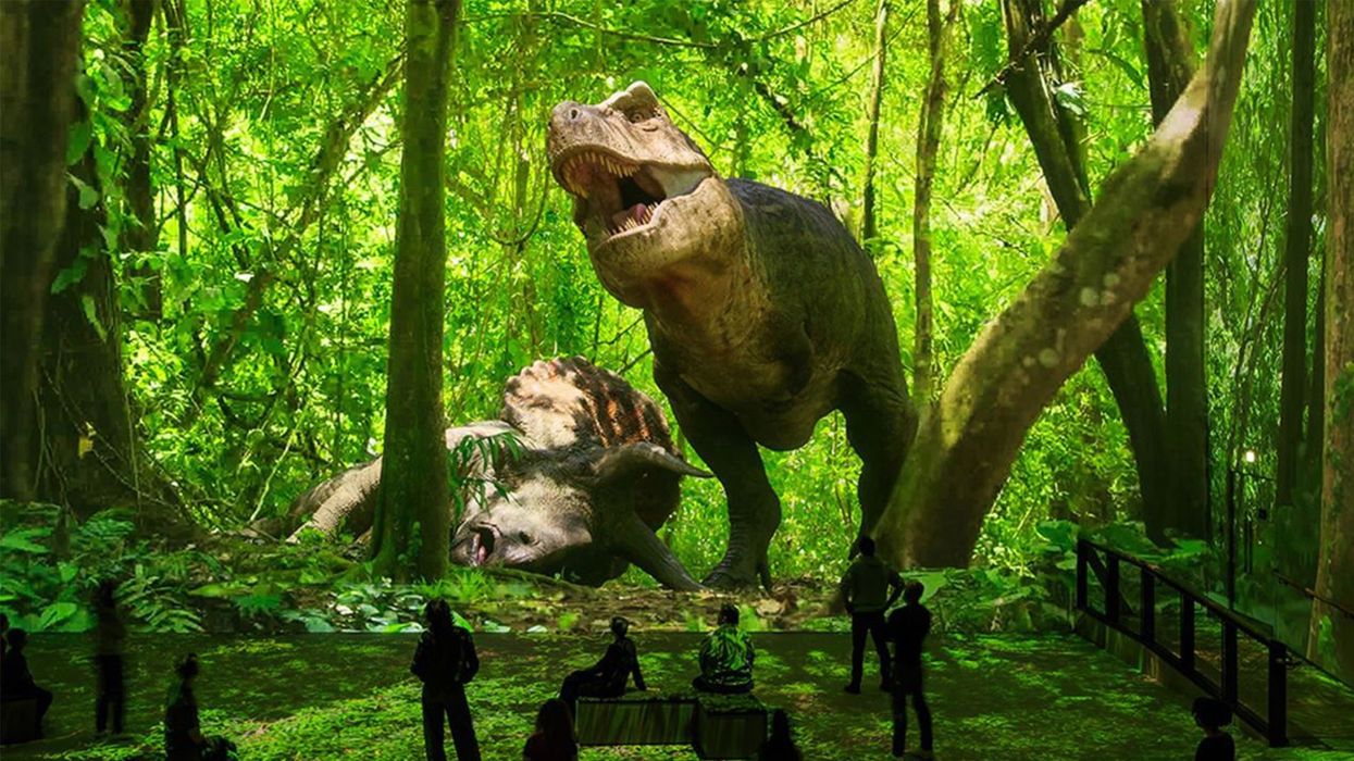 Digital T. rex and Triceratops in jungle, viewed by silhouetted museum visitors.