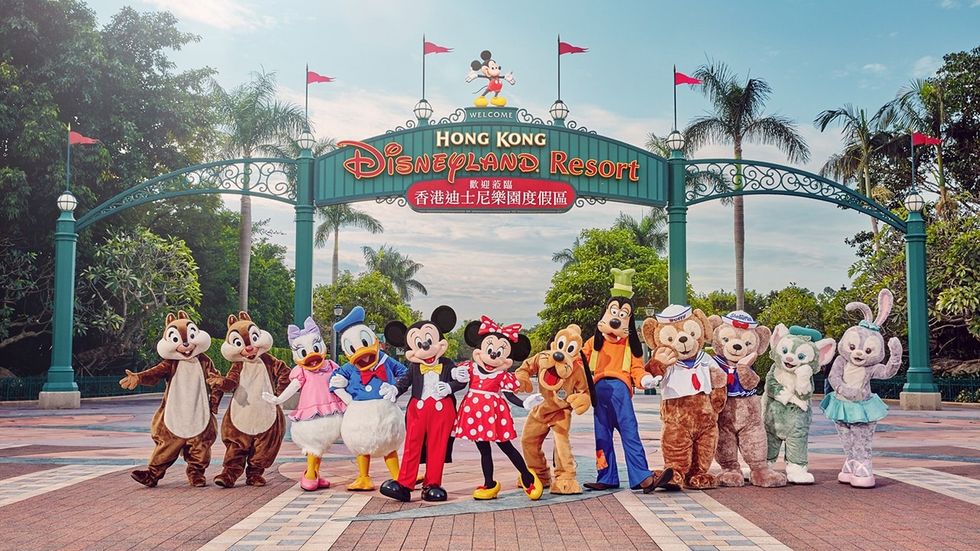 Disney characters pose at Hong Kong Disneyland entrance gate.
