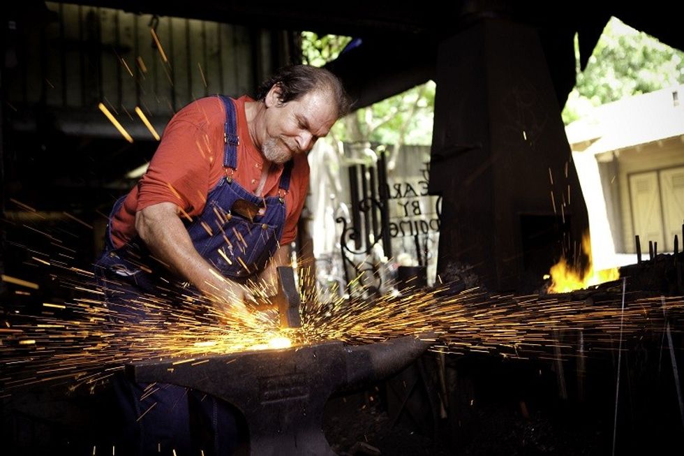 dollywood blacksmith sparks forging man